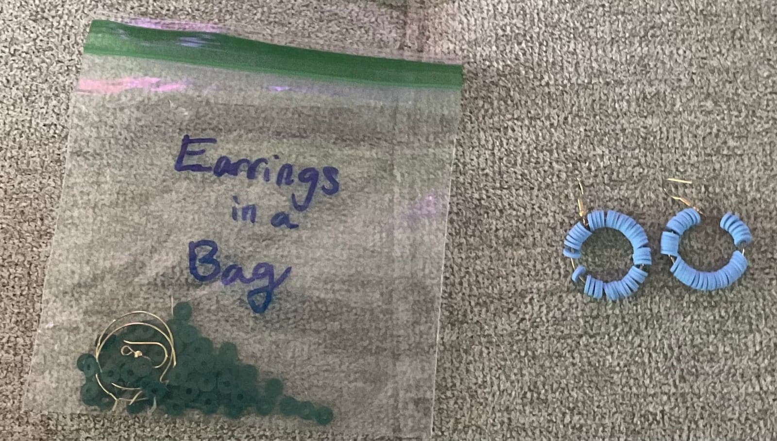 A pair of small blue hand-beaded hoop earrings