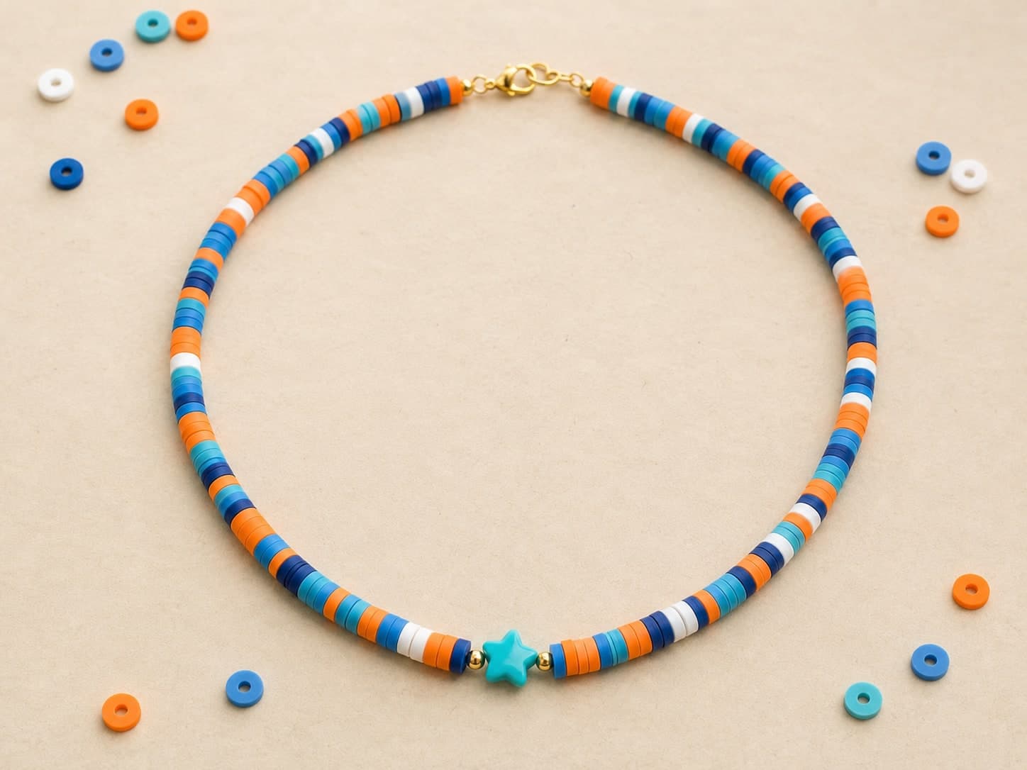 Blue and orange clay-bead necklace with a turquoise star bead