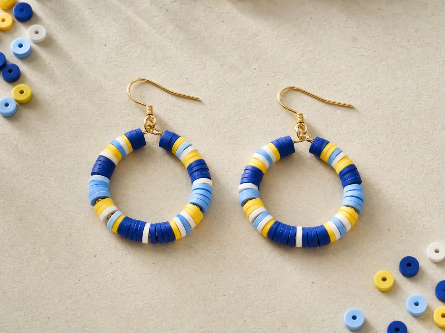 Blue, yellow, and white clay-bead hoop earrings