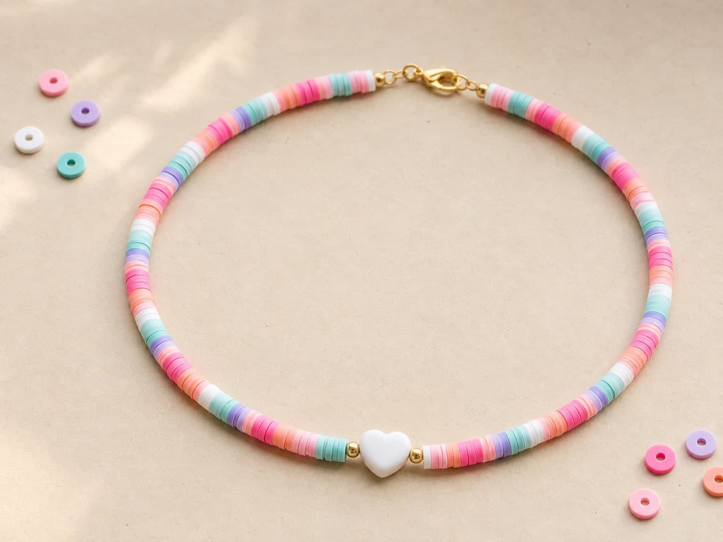 Pastel clay-bead necklace with a white heart bead
