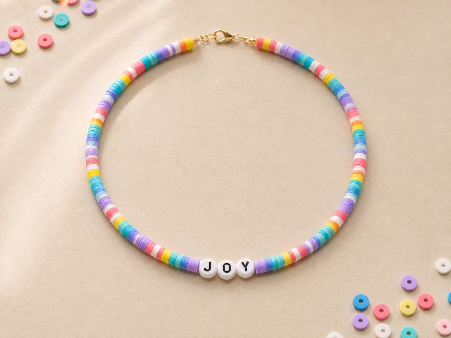 Rainbow clay-bead necklace spelling JOY