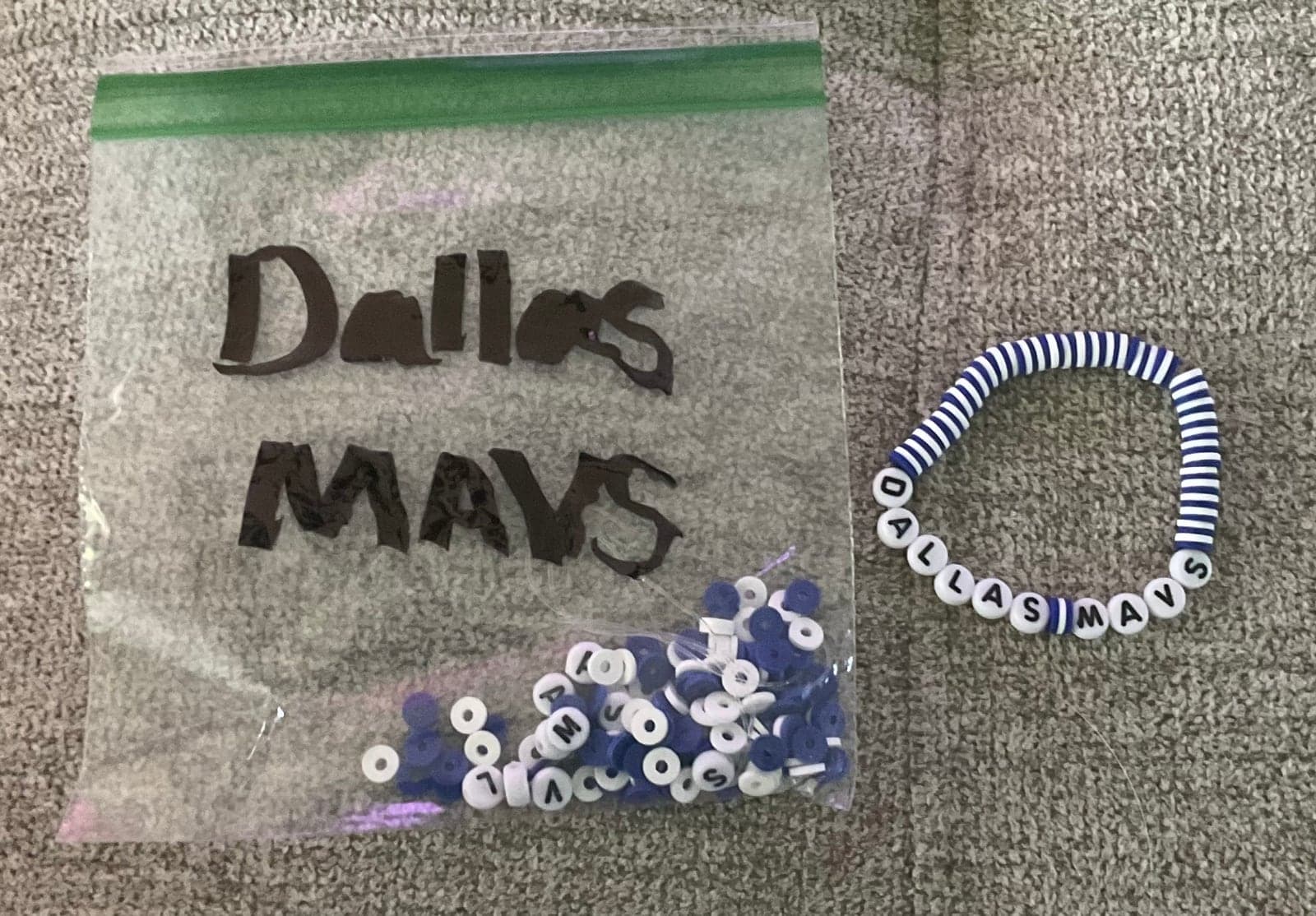 Blue and white beads beside a handmade team-inspired bracelet