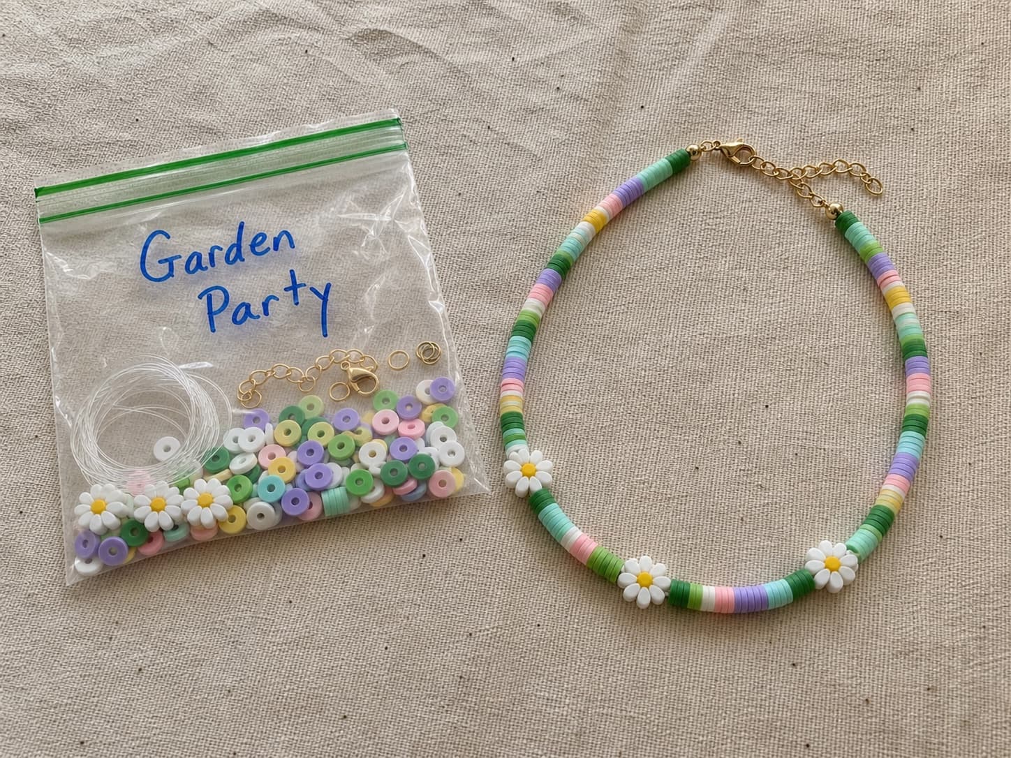Handmade Garden Party necklace beside its clear DIY bead kit