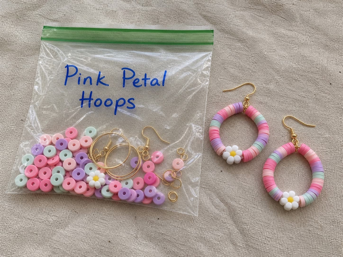 Handmade Pink Petal hoop earrings beside their clear DIY kit